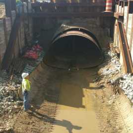 The shoulder of the interstate collapsed/failed, leaving a construction pit.