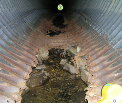 Culvert with deteriorating and corroded invert.